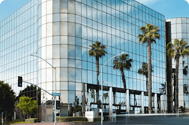 Modern glass corporate building with palm trees